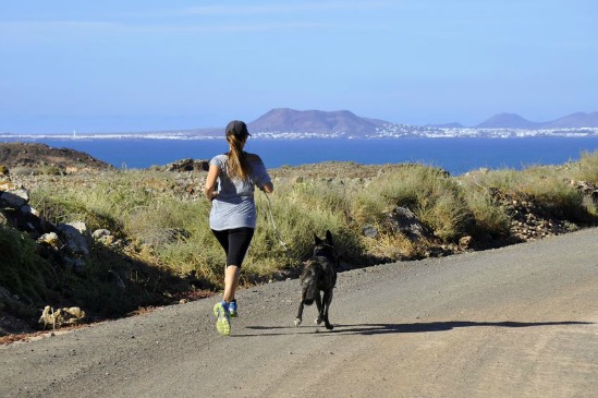 woman running with her dog. https://www.info-on-high-blood-pressure.com/Pets-And-High-Blood-Pressure.html